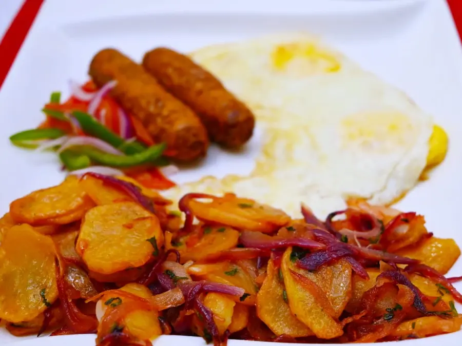 Cooked breakfast of eggs, sausages and potatoes