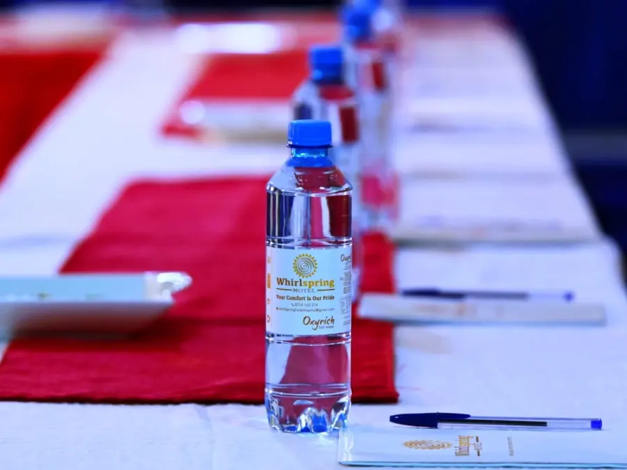 Conference table with notepads and water